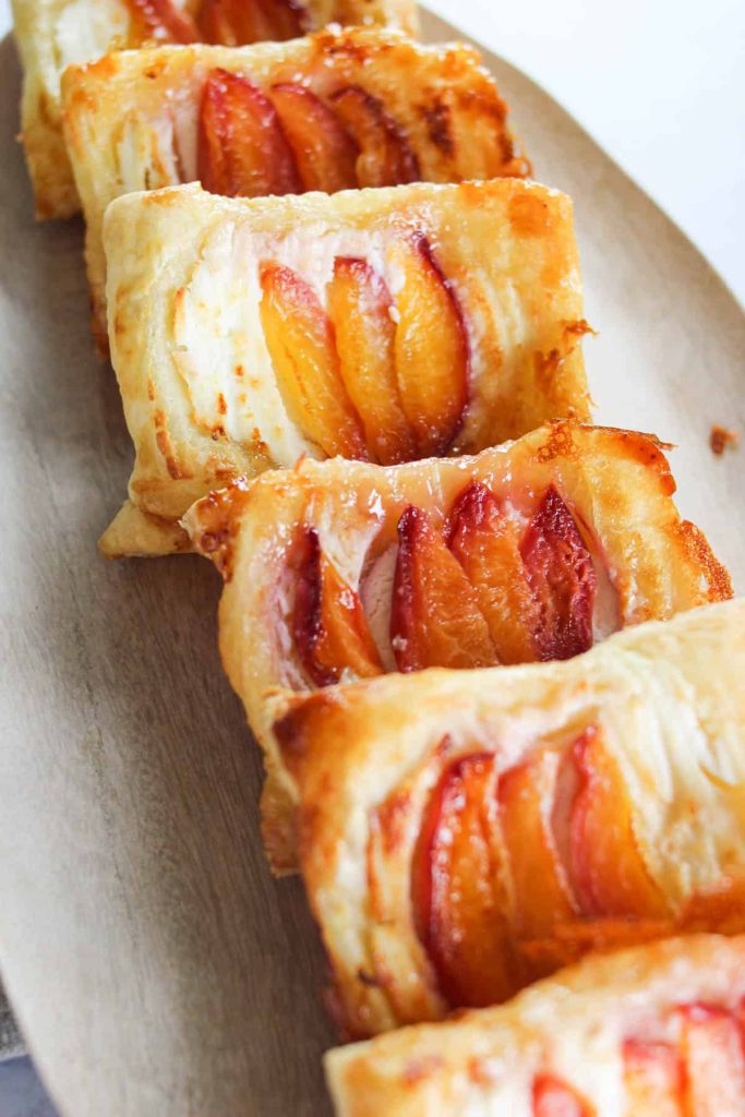 Up close shot of peach puff pastries on a serving platter. 