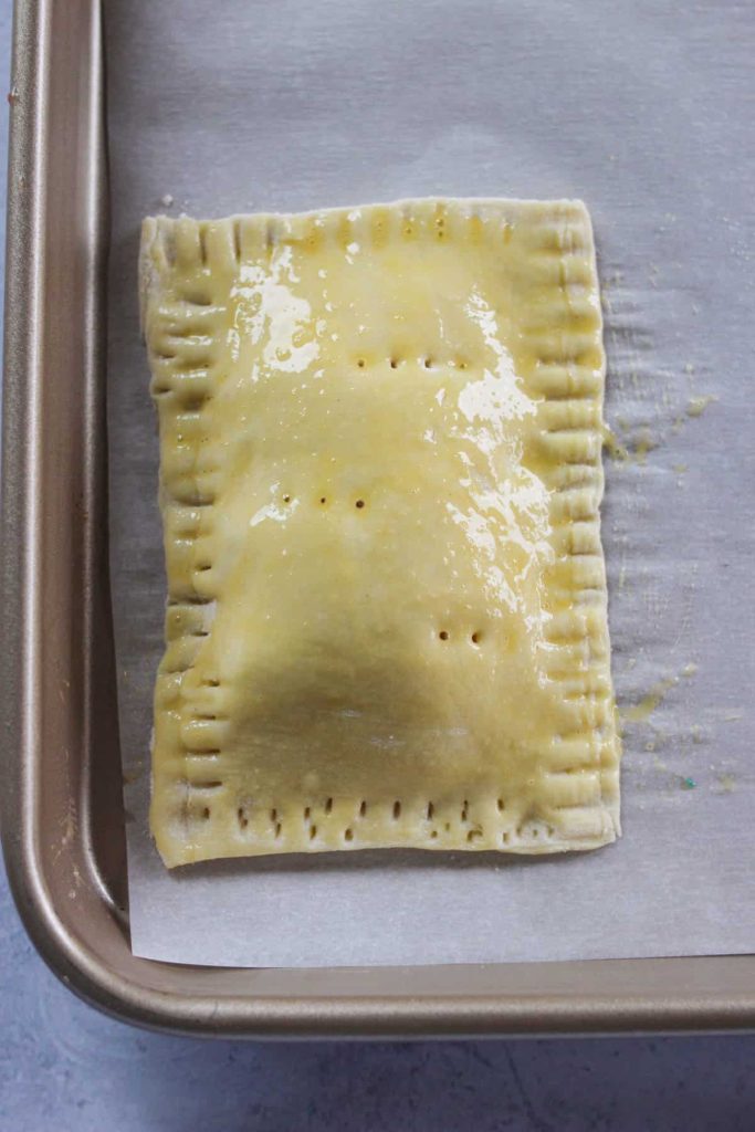 Puff pastry on a baking sheet with an egg wash. 