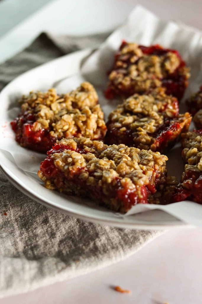 Oatmeal bars on a plate lined with parchment paper. 