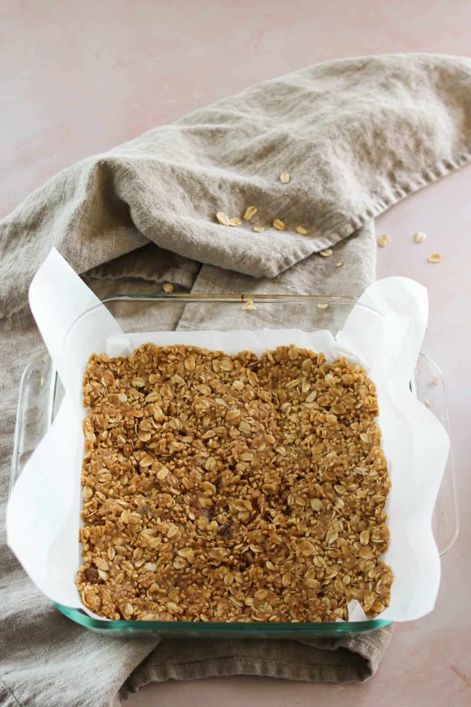 Oatmeal mixture in a layer in a baking dish. 