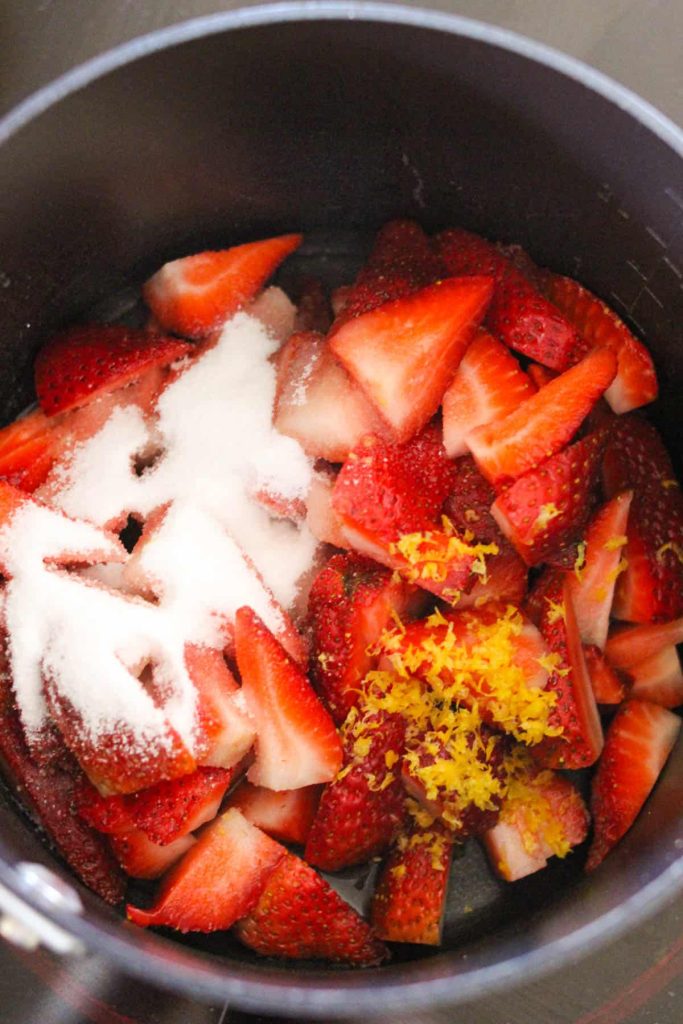 Strawberries, sugar and lemon in a saucepan. 