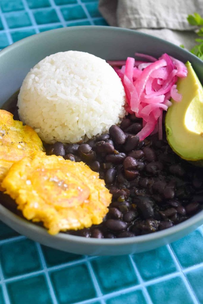 Plantains served with beans, rice, onions and avocado. 