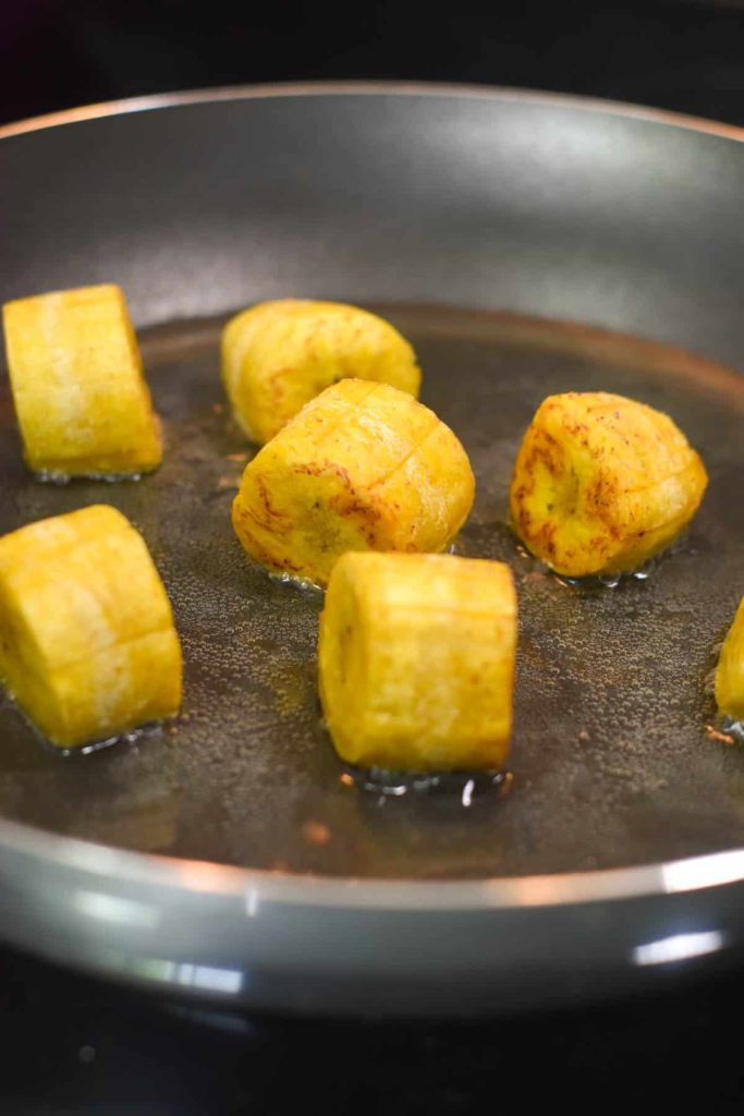 Plantain pieces on their side to get each side crispy in the oil. 