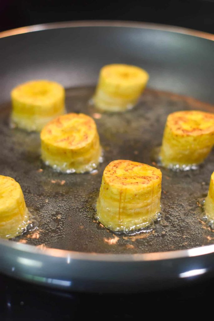 Plantain chunks flipped to fry on the other side. 