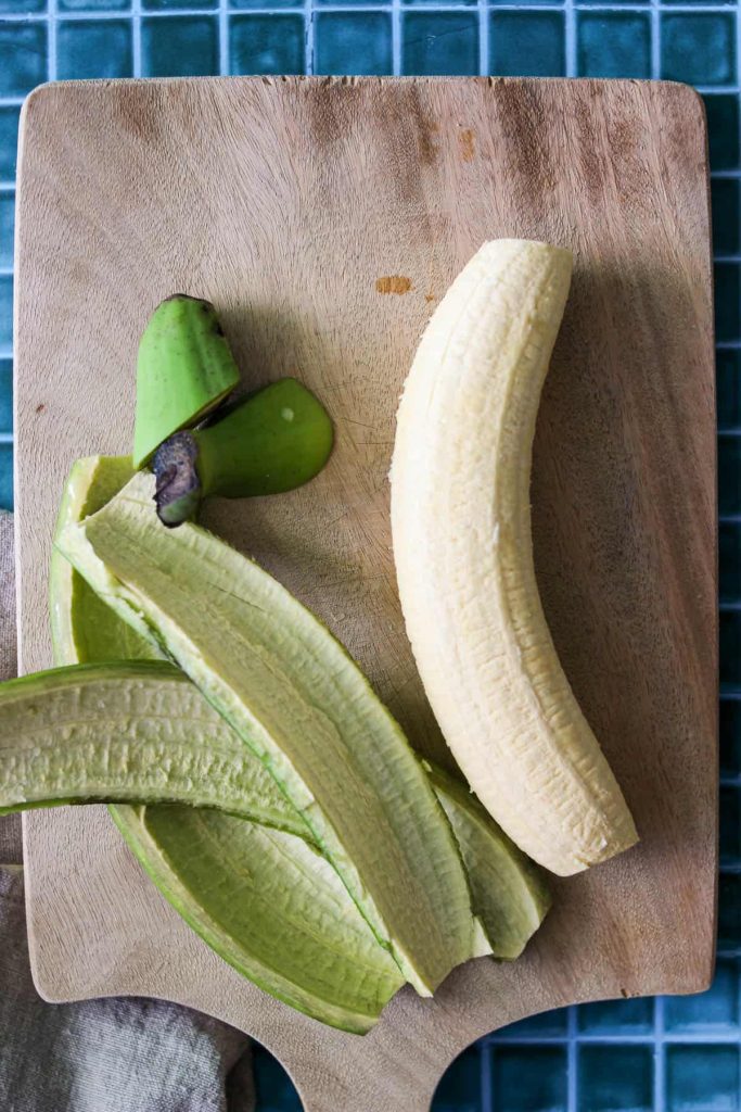 Plantain after the peel is removed and on a cutting board. 