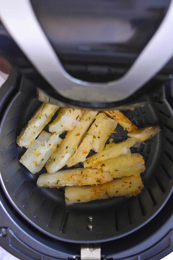 Yuca fries in the air fryer before being cooked. 