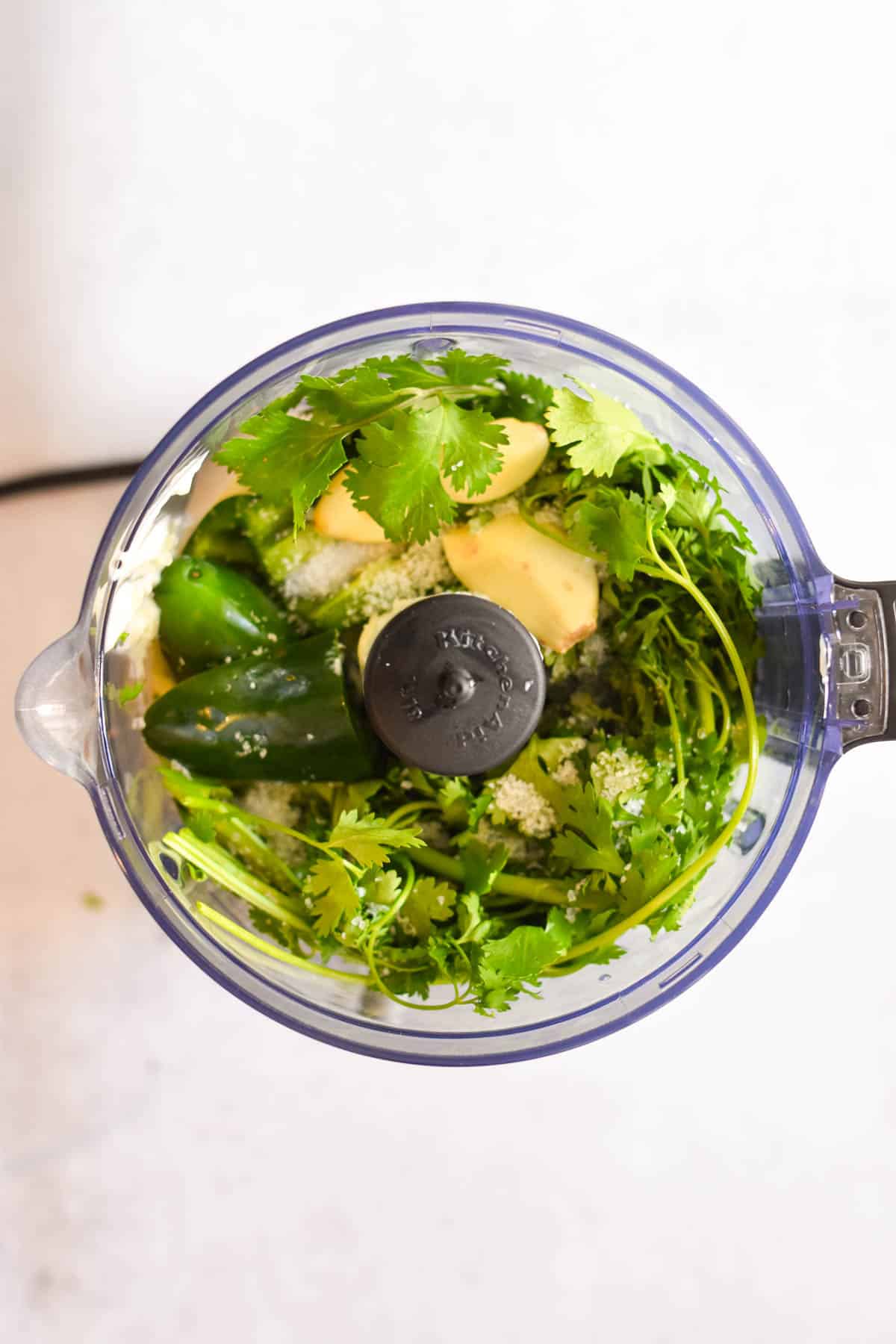 Overhead shot of all ingredients in a food processor. 