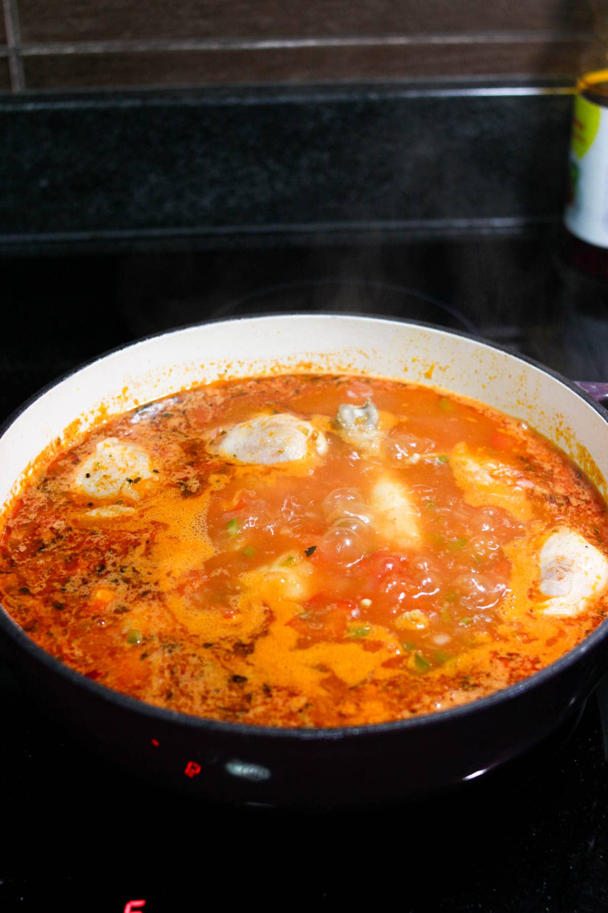 Seco de pollo simmering in a dutch oven on the stove. 