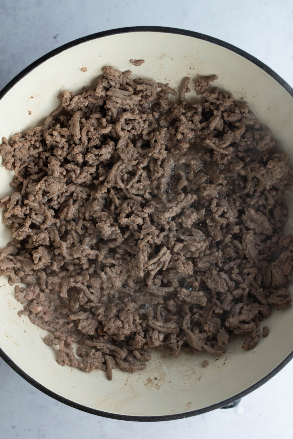 Ground beef being cooked in a skillet. 