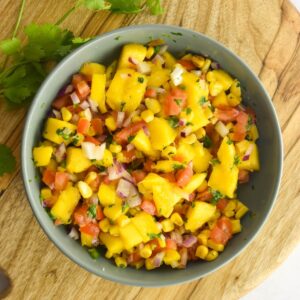 Overhead shot of corn mango salsa in a bowl.