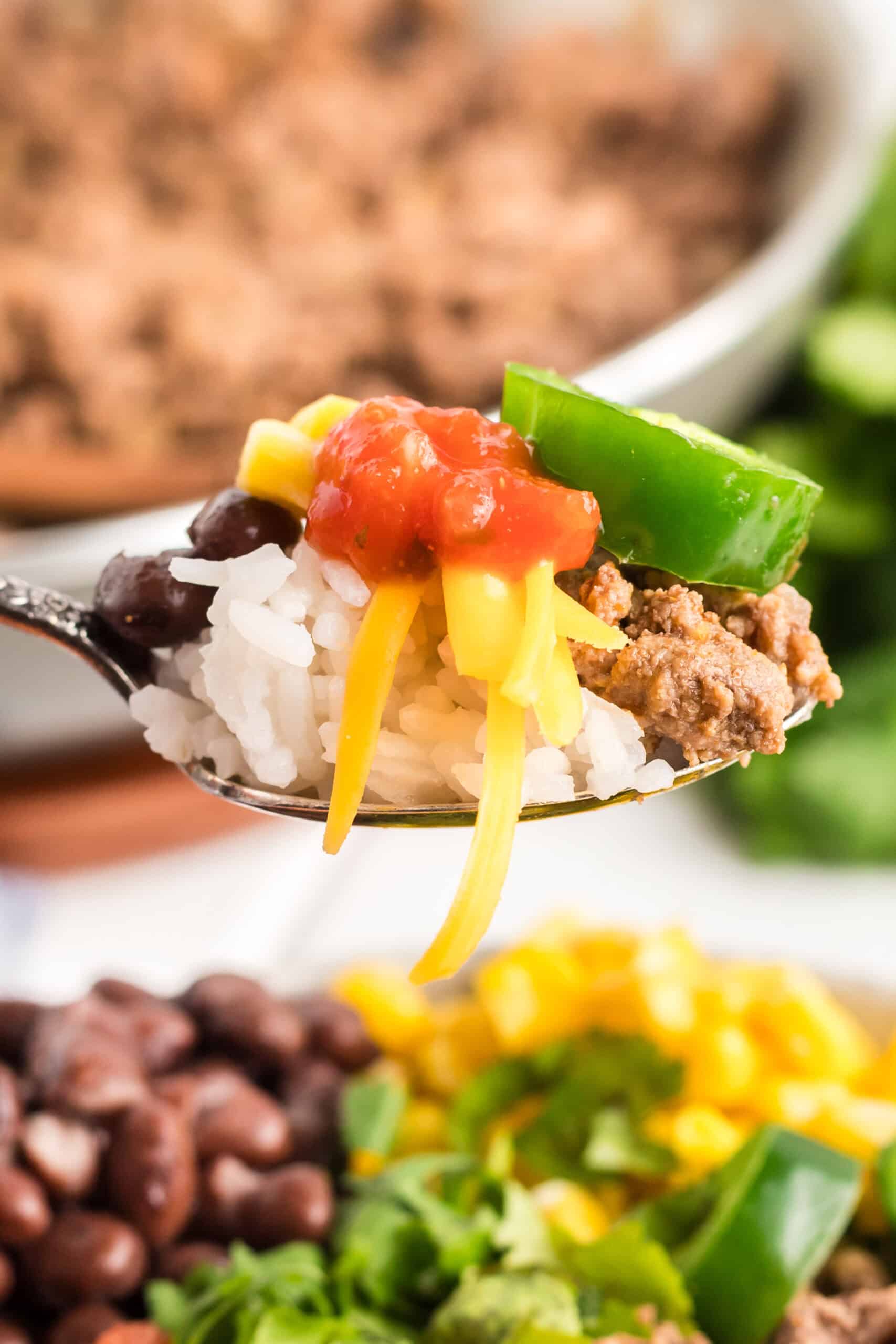 Spoon scooping up a bite of taco bowl.