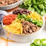 Taco bowl with all the toppings including ground beef, corn, cheese and salsa.