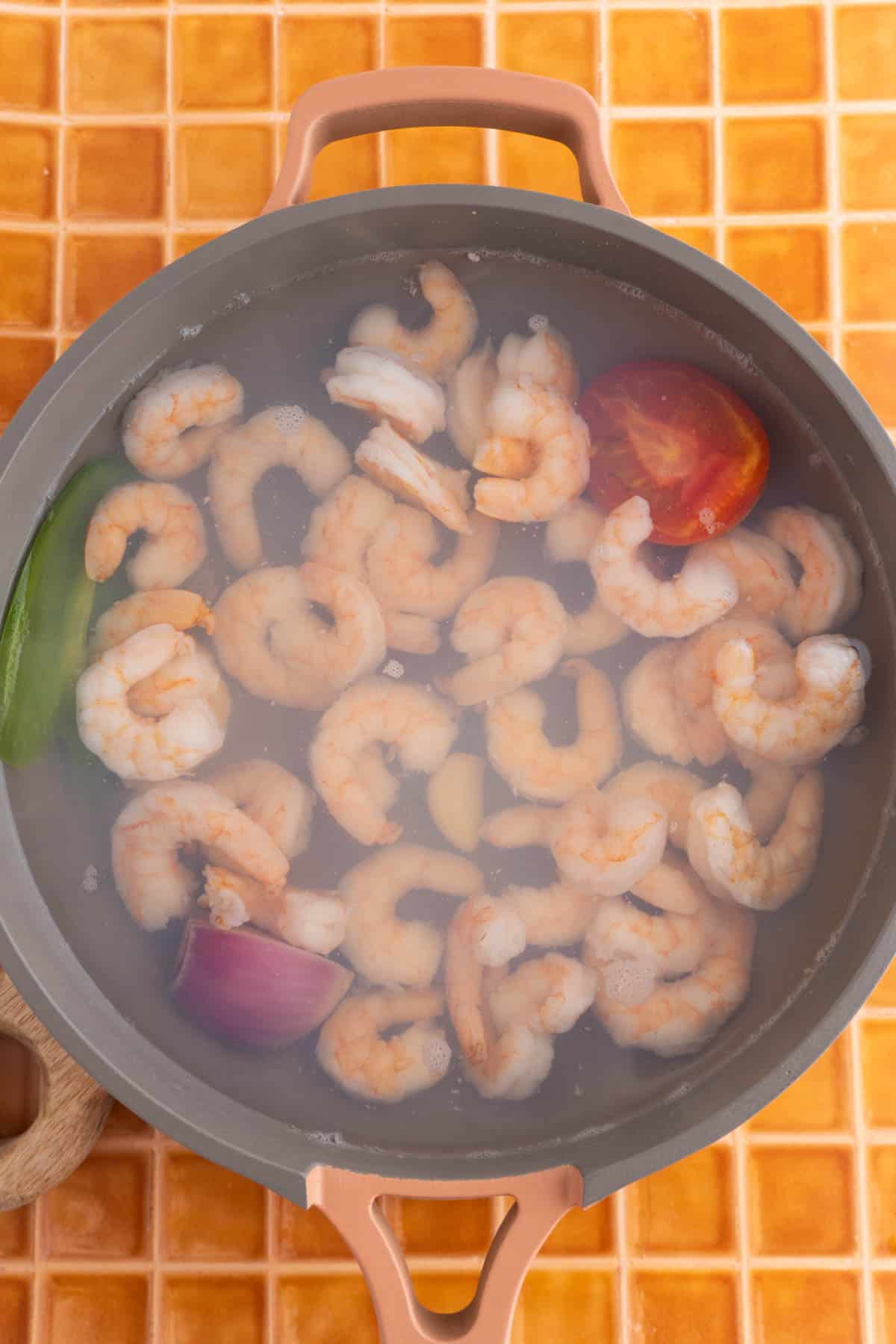 Shrimp added to the water with the vegetables.