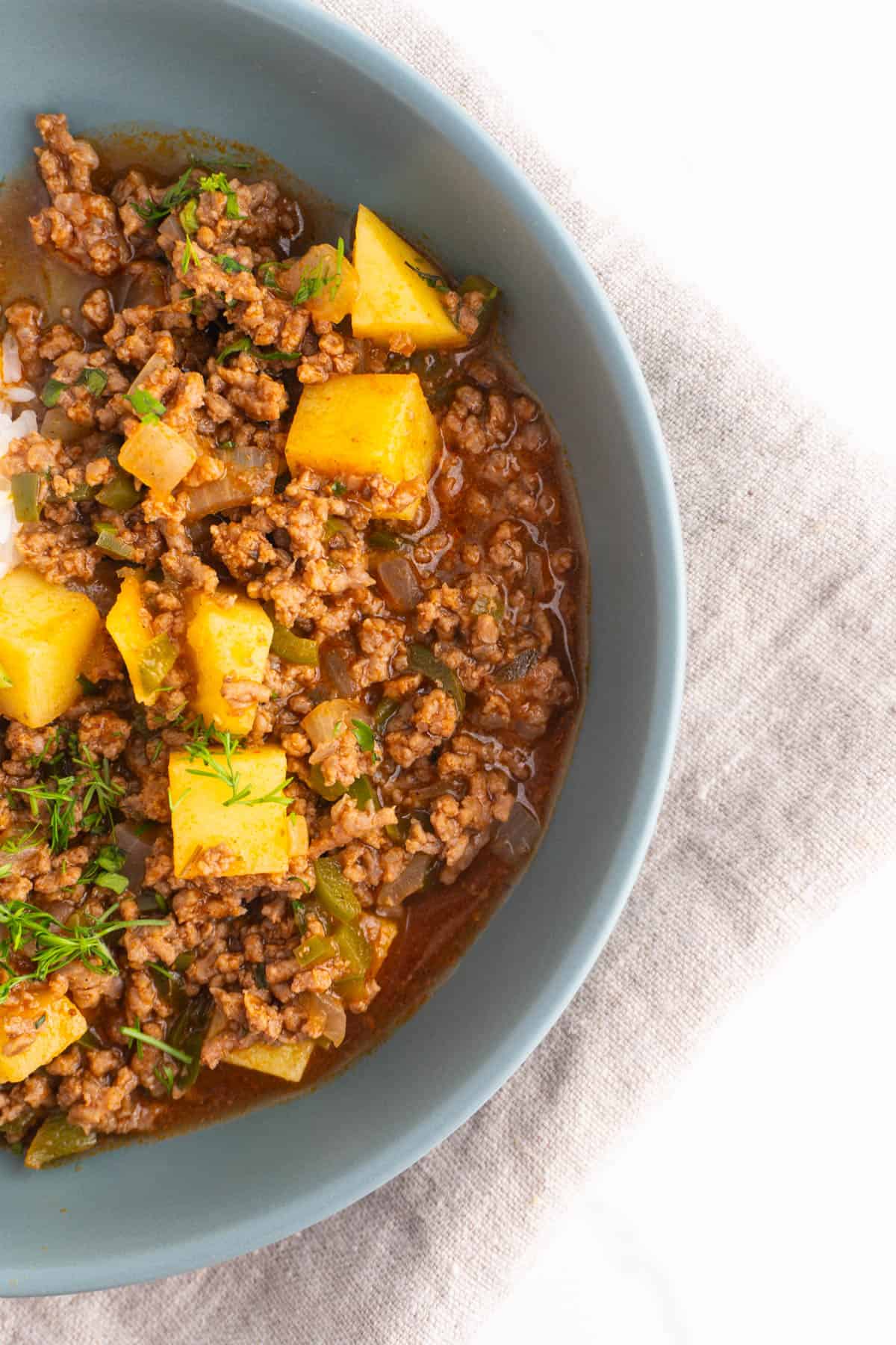 Overhead shot of one half of the bowl with ground beef picadillo in it.