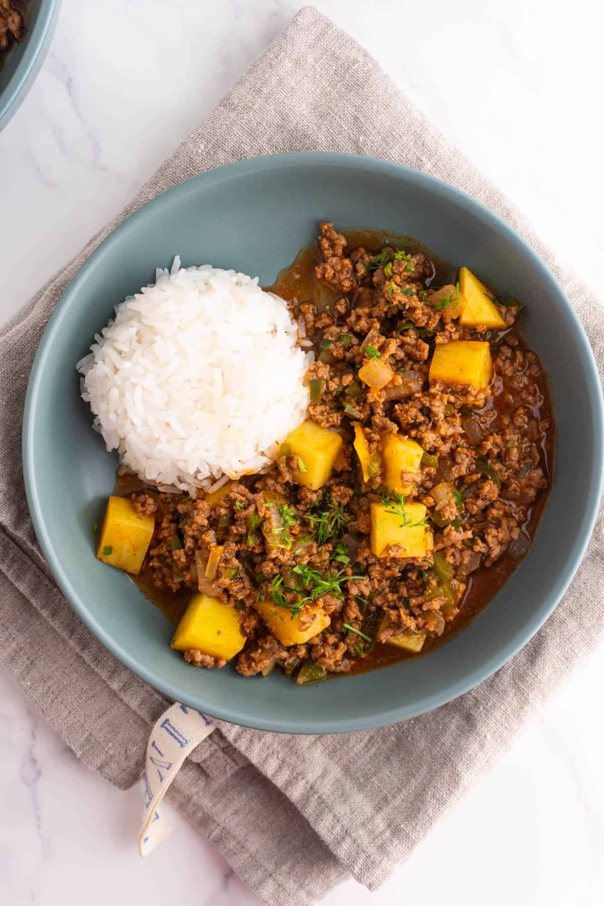 Mexican picadillo served with rice and some cilantro on top.